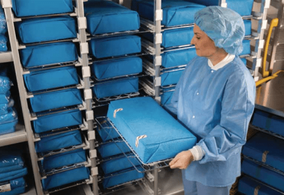 CSSD worker transporting trays