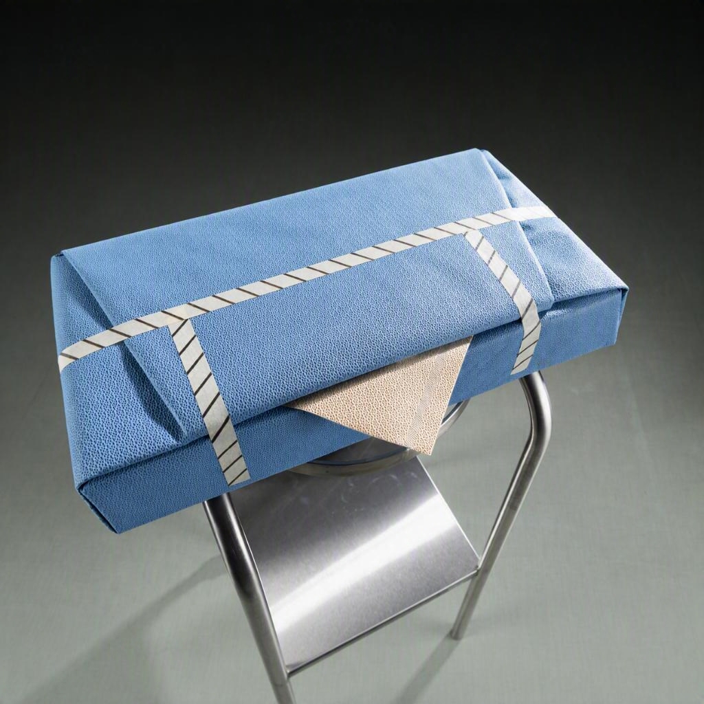 Amber ASSURE-DRY inner layer of ARMOR-FLEX wrap peeled back over a sterilised instrument tray